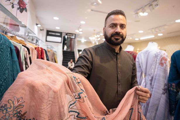 Salman Khawaja, who owns Jora Junction dress shop, says rats from fly-tipping have made their way into his stockroom and chewed through three suits - and also while the dresses have been hung up on the shop floor
Salman with a damaged scarf