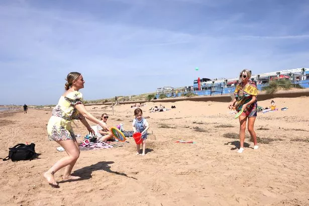 People enjoy the hot weather on Crosby beach