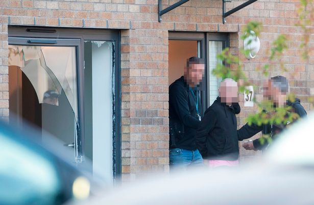 A suspect was led away from the house in Barlanark