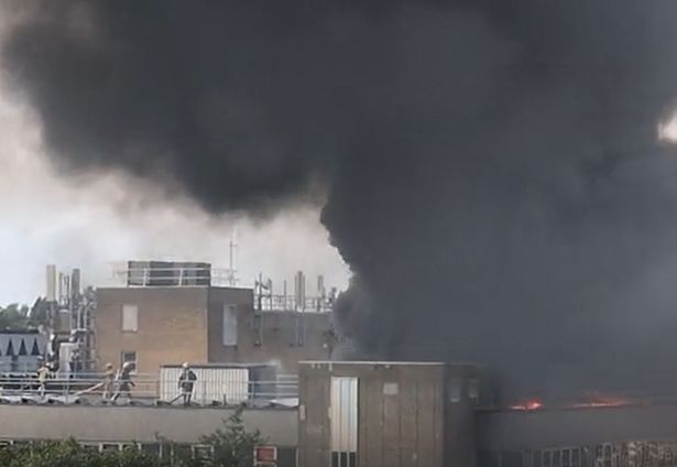 Firefighters battle the blaze on the roof of St Michael's Hospital in Bristol 