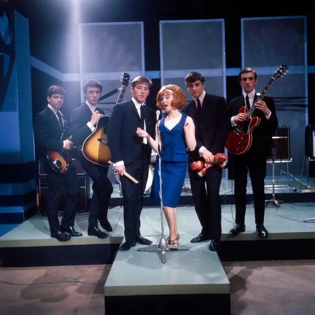 Lulu performs on a television show with her backing group The Luvvers in 1964. From left to right: Tommy Tierney, James Dewar, David Mullin, Lulu, Alex Bell and Ross Neilson.