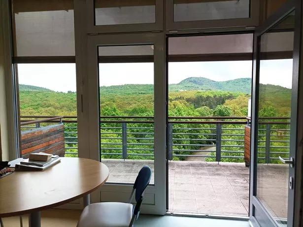 A photo of Anna's room showing a table and a door leading out to a balcony