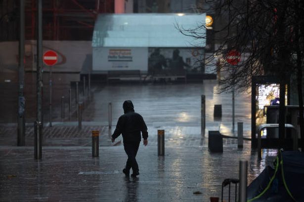 A man walks in heavy rain on January 24, 2025 in Glasgow, Scotland, United Kingdom. 