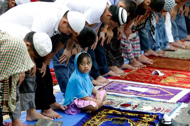 Filipino Muslims attend an early morning prayer to mark Eid al-Adha at the Blue Mosque in suburban Taguig, east of Manila, Philippines