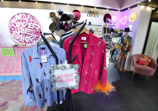 This photo shows a purple embellished shirt and pink blazer surrounded by other items in All Over the Shop in the Metquarter.