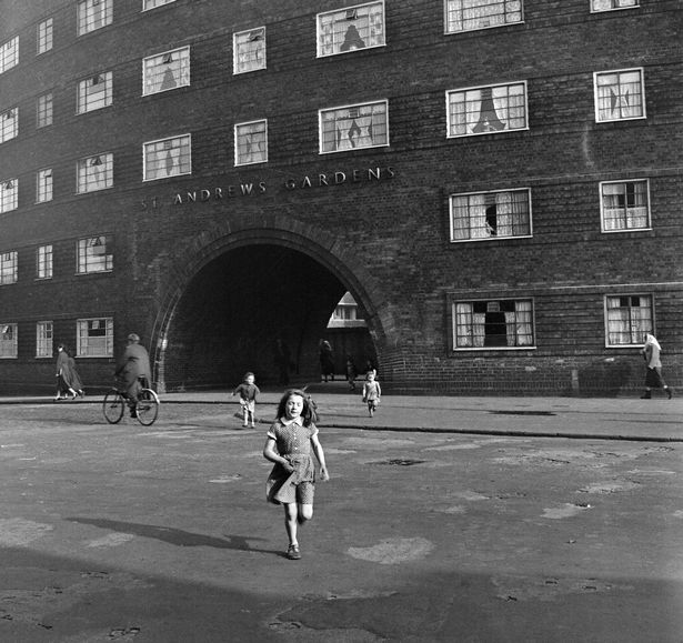 Young girl outside St Andrews Gardens housing.