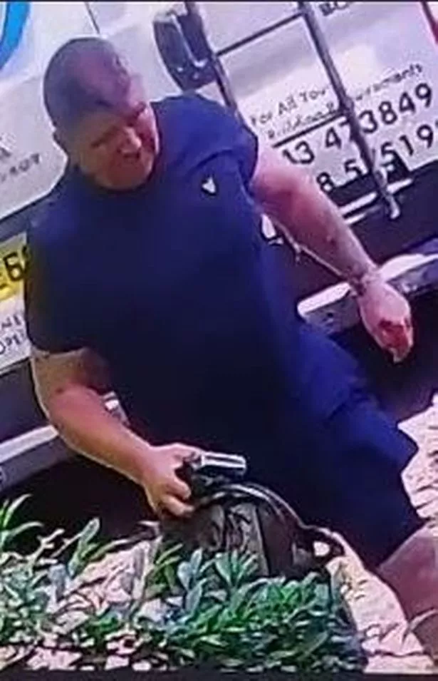 A man in dark shorts and T-shirt carrying a rucksack
