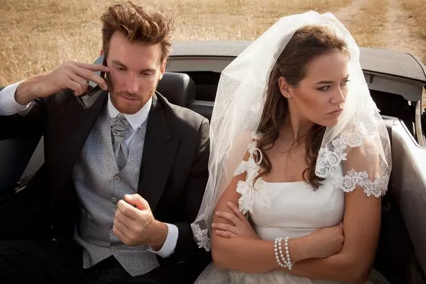 A newlywed couple arguing in the car