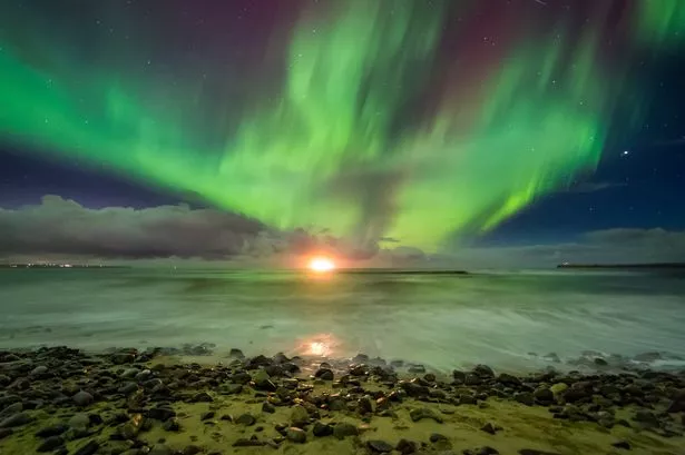 A burst of aurora over the hills in Caithness, Scotland