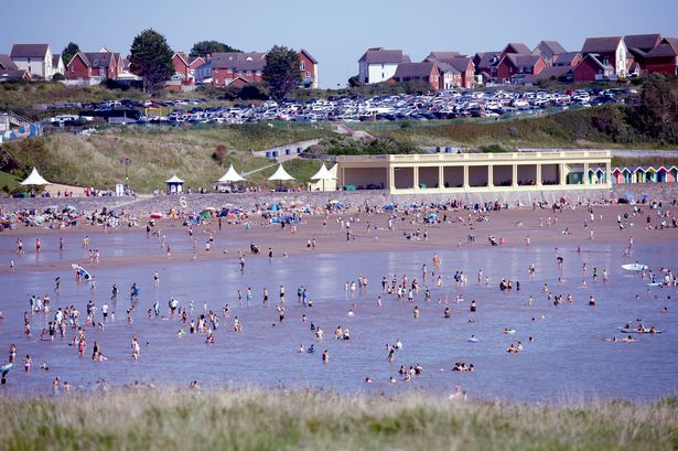 People enjoying a sunny day at the seaside and Barry Island 