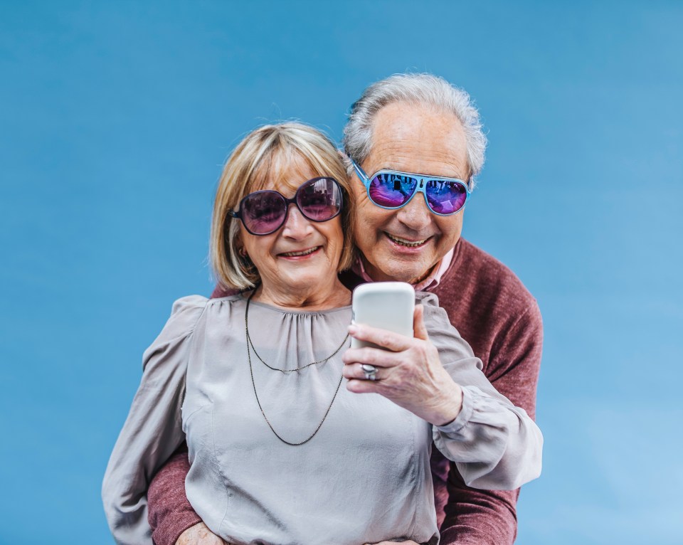 Happy senior couple taking a selfie.