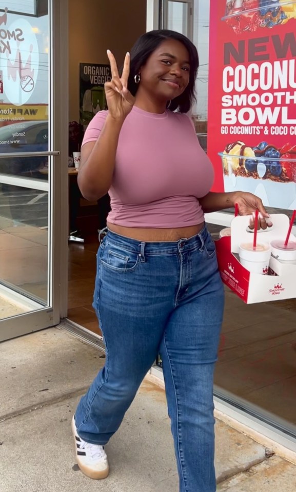 Woman leaving Smoothie King with smoothies.