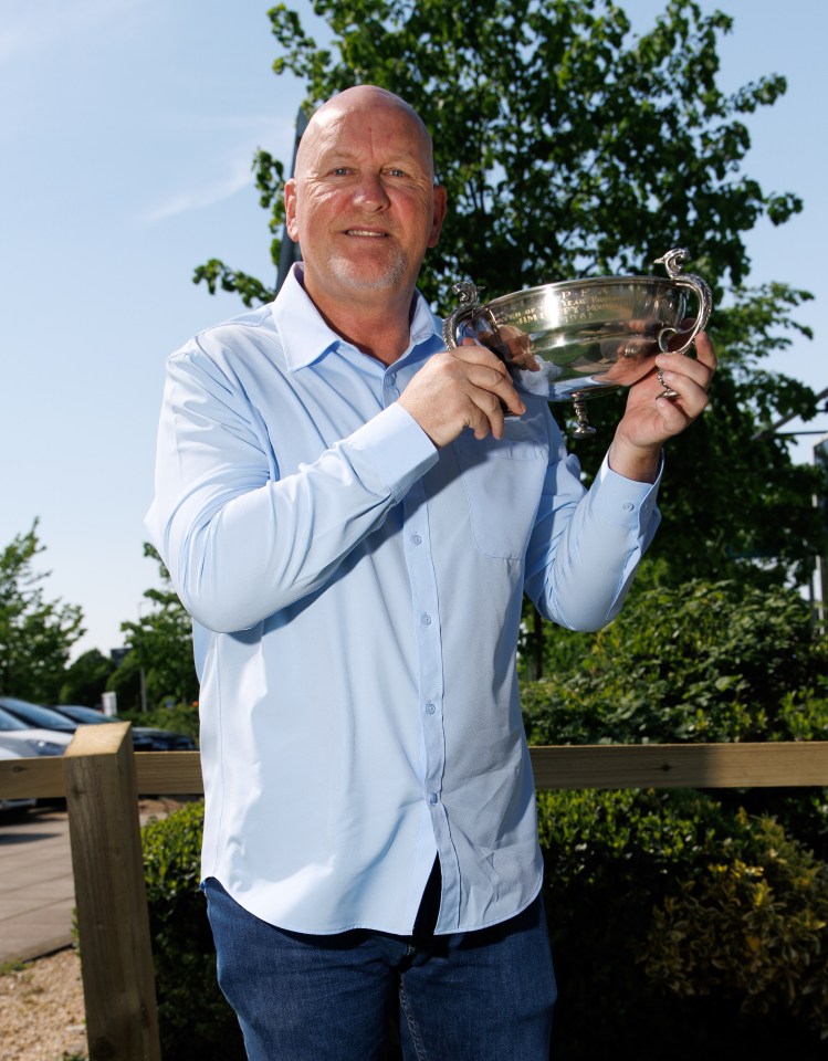 Man holding a trophy.