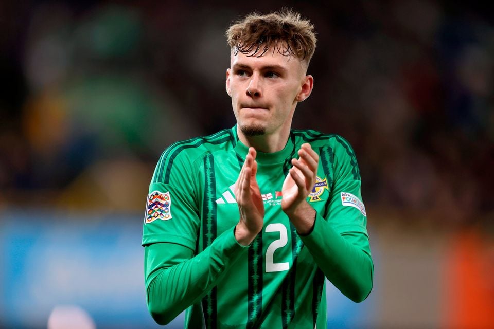 Northern Ireland's Conor Bradley applauds the fans at Windsor Park