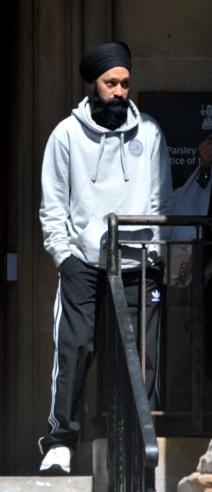 Man in a grey hoodie and black Adidas sweatpants standing on steps outside Paisley Sheriff Court.