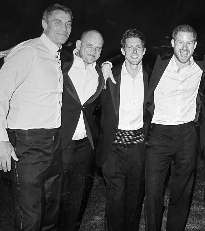 Black and white photo of Prince Harry with his friends at his wedding.