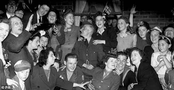 Embargoed to 0001 Wednesday April 29File photo dated 08/05/45 of VE (Victory in Europe) Day celebrations in the East End of London, marking the end of the war in Europe. A teenage Princess Elizabeth danced in jubilation on VE Day after slipping into the crowds unnoticed outside Buckingham Palace. PA Photo. Issue date: Wednesday April 29, 2020. The future Queen, then just 19, and her sister Princess Margaret, 14, joined thousands of revellers as they gathered in front of the royal residence on May 8 1945. See PA story MEMORIAL VE Queen. Photo credit should read: PA/PA Wire