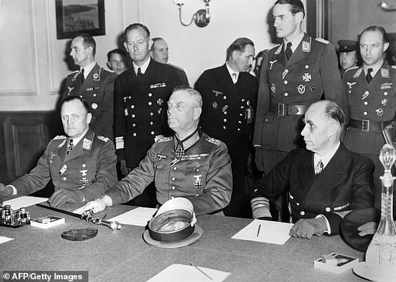 A photo taken late 08 May1945 at the headquarters of the Soviet forces in Berlin-Karlshorst shows (sitting from L) German General Hans-J rgen Stumpff of the Luftwaffe, German Field Marshal and German chief-of-staff Wilhelm Keitel, and Admiral Hans-Georg Von Friedeburg of the German Navy, posing before officially signing the German definitive act of surrender in the Berlin suburb of Karlshost. The date that World War II finally came to an end in Europe is still a matter for debate. For the British and Americans it ended on May 7, 1945 with the signing of the German surrender in Reims. For the Russians, it was the signature of the unconditional surrender in Berlin on May 9 and for the French it remains May 8, the day the fighting actually came to a halt. AFP PHOTO FILES(Photo credit should read STF/AFP/Getty Images)BER80