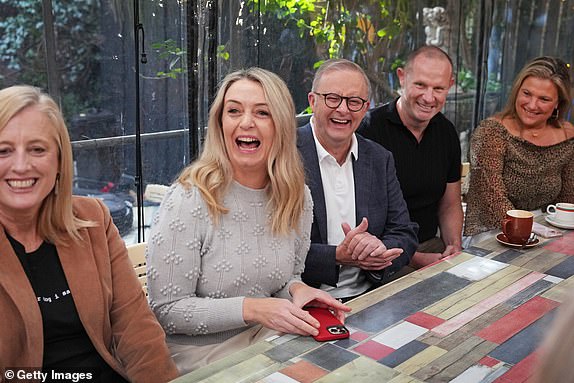 SYDNEY, AUSTRALIA - MAY 04: Australian Prime Minister Anthony Albanese joined by fiancÃ©e Jodie Haydon (C)Â visits Bar Italia in Leichhardt on May 04, 2025 in Sydney, Australia. Anthony Albanese has secured a historic second term as Australia's prime minister, with Labor achieving a landslide victory and expanding its parliamentary majority amid widespread swings across the country. His win is seen as a public endorsement of Labor's focus on cost-of-living relief, healthcare, and stability in a period marked by global uncertainty and economic challenges. (Photo by Asanka Ratnayake/Getty Images)