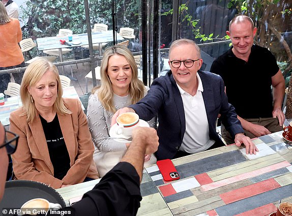 Australia's re-elected Prime Minister Anthony Albanese and his partner Jodie Haydon (C) pick up their coffee order at a cafe while visiting his Sydney electorate on May 4, 2025, following his party's decisive victory in the federal election. (Photo by DAVID GRAY / AFP) (Photo by DAVID GRAY/AFP via Getty Images)