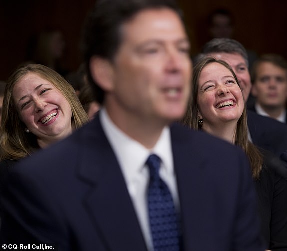 UNITED STATES - JULY 9: James Comey, nominee for FBI Director, shares a laugh during his conformation hearing before the a Senate Judiciary Committee in Dirksen Building as his daughters Kate, left, and Maureen and his wife Patrice, look on. (Photo By Tom Williams/CQ Roll Call)