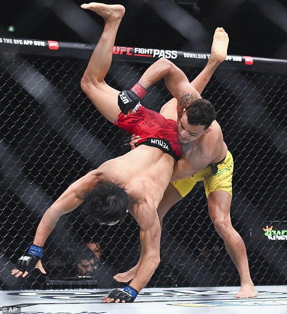Daniel Santos, right, takes down Jeong Yeong Lee, left, during their UFC 315 featherweight mixed martial arts bout in Montreal, Saturday, May 10, 2025. (Graham Hughes/The Canadian Press via AP))