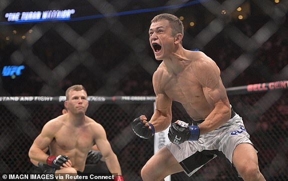 May 10, 2025; Montreal, Quebec, CANADA; Bekzat Almakhan (blue gloves) reacts after defeating Brad Katona (red gloves) during UFC 315 at Bell Centre. Mandatory Credit: Eric Bolte-Imagn Images