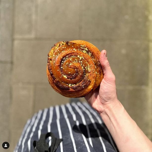 A hand holding a pastry