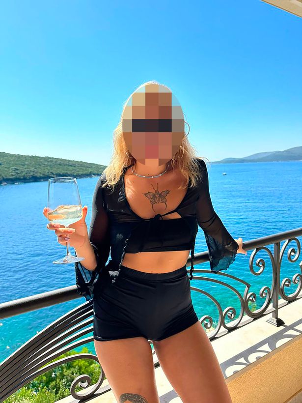 The model pictured holding a drink