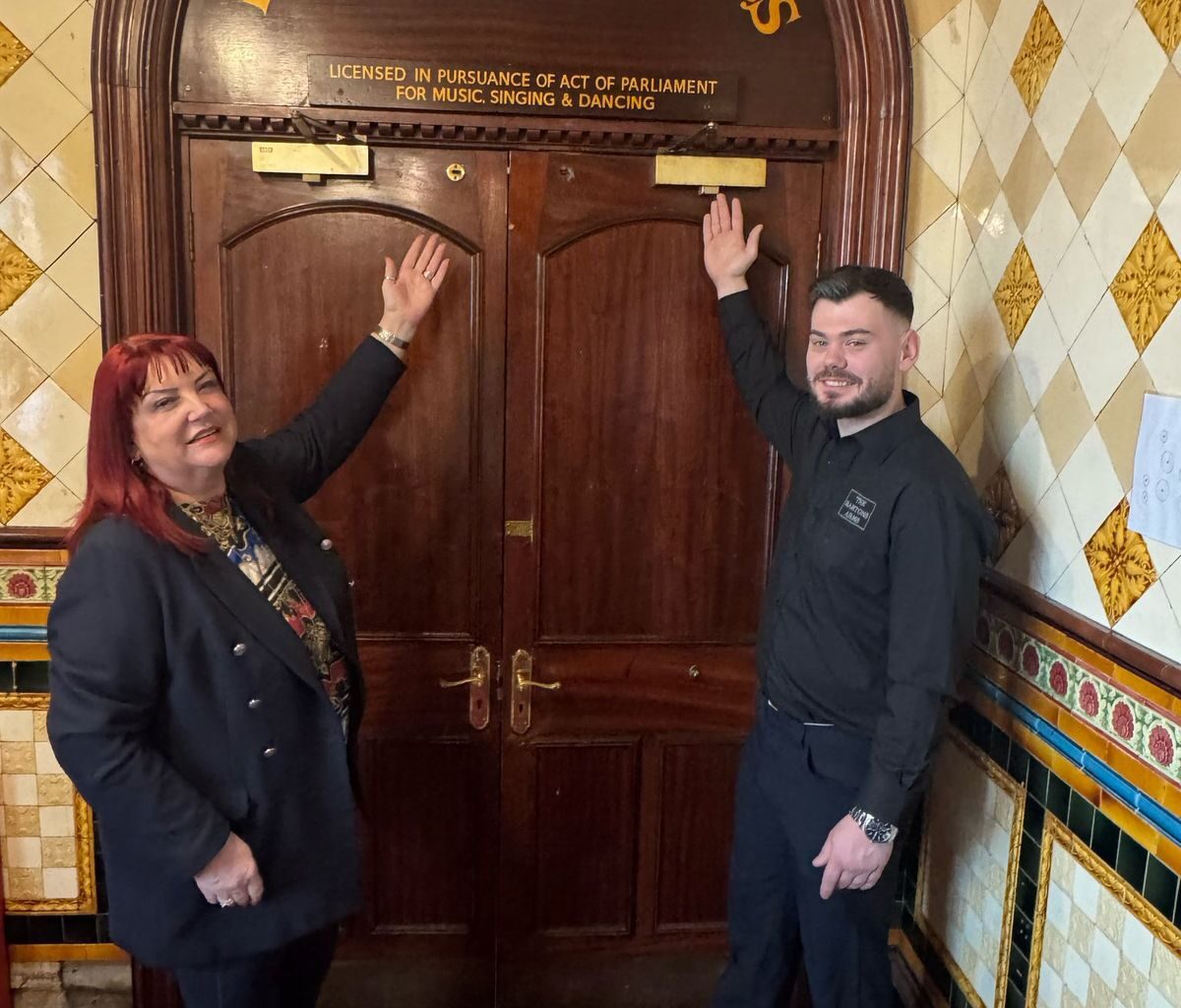 Angela Nelson and Nathan O'Neil with the rediscovered Palace of Varieties sign at the Bartons Arms