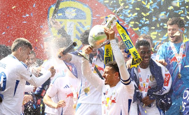 Ethan Ampadu of Leeds United lifts the Championship trophy
