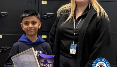 Ayaan, 8, pictured with his award and chocolates alongside call handler Rebecca