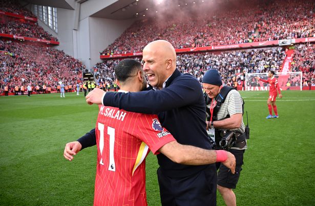 Arne Slot, Manger of Liverpool, embraces Mohamed Salah of Liverpool, as they celebrate the teams victory and confirmation of winning the Premier League title after the Premier League match between Liverpool FC and Tottenham Hotspur FC at Anfield on April 27, 2025 in Liverpool, England