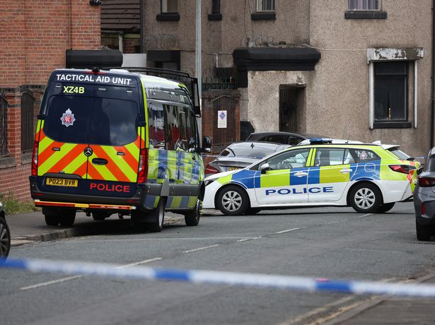 Police at the scene of the double stabbing in Cobden Street, Pendleton.