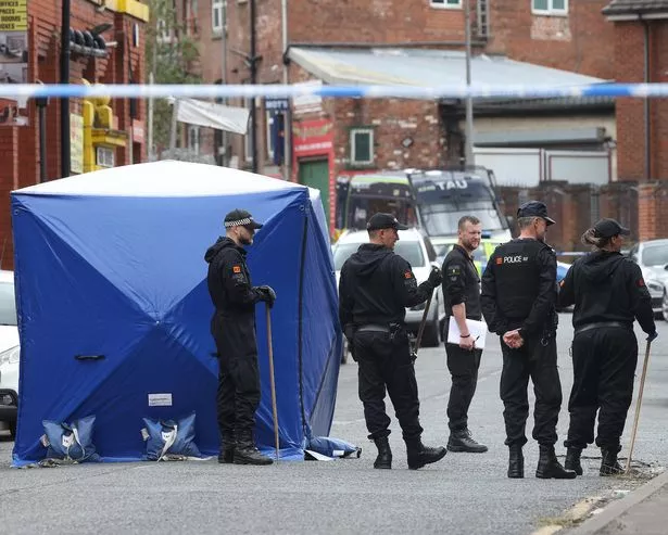 Police in Cobden Street, Pendleton, today after a double stabbing left a man fighting for his life. 