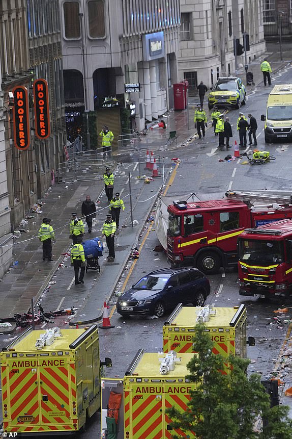 Police and emergency personnel deal with an incident after a car collided with pedestrians near the Liver Building during the Premier League winners parade in Liverpool, England, Monday, May 26, 2025.(AP Photo/Jon Super)