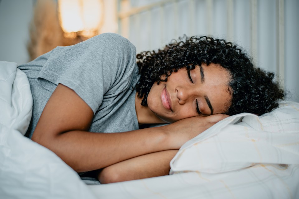 Teenage girl sleeping in bed.