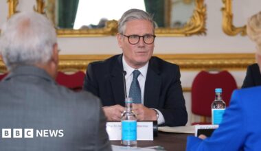 Sir Keir Starmer sitting at a table in Lancaster House, opposite European Commission President Ursula von der Leyen and European Council President Antonio Costa, who have their back to the camera.