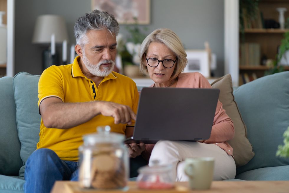 Pensioners look at laptop