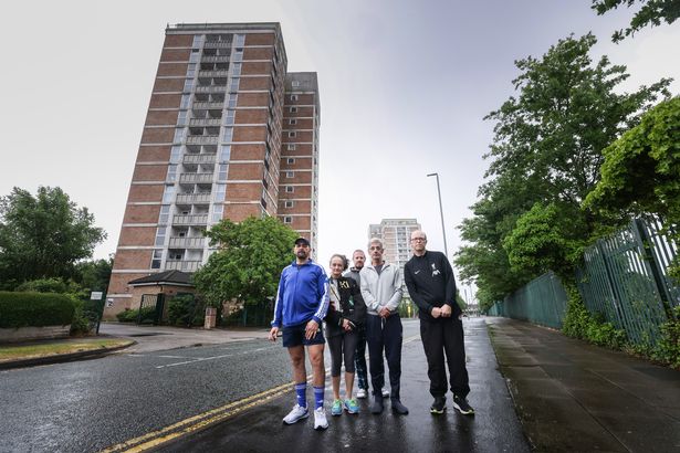 Residents Paul, Kelly Cox, Phil, Hossein Heravi and Chris Penfold-Ivany outside Beech Rise in Kirkby with Willow Rise visible in the background