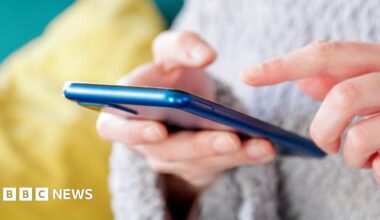 A stock image of someone texting on a mobile phone.