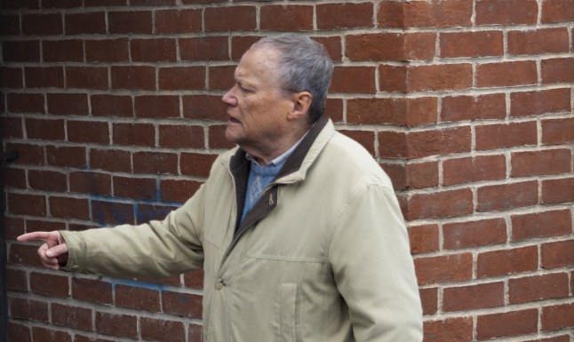 Roy Cropper pointing at something in Coronation Street, looking concerned.