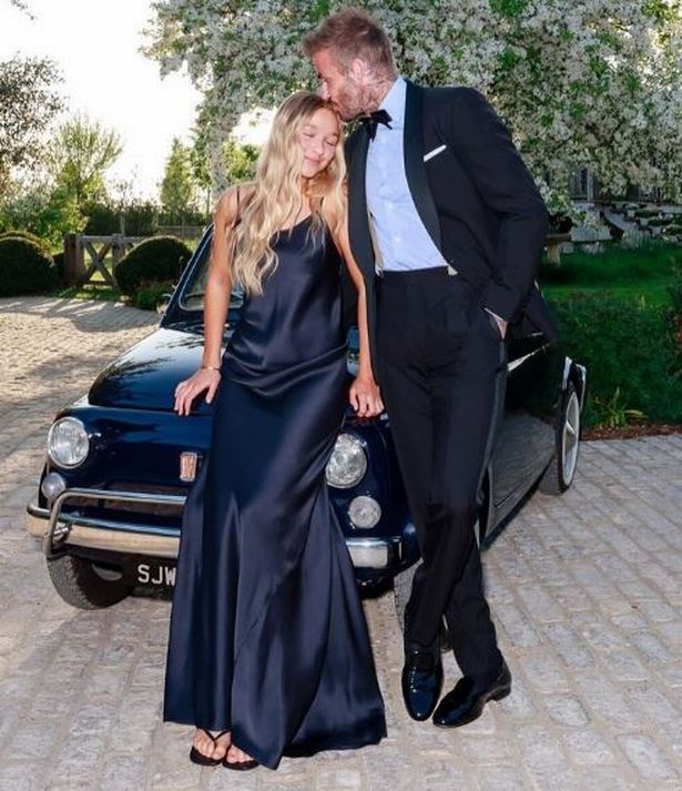 One photo saw Beckham lovingly kissing his daughter Harper on the head