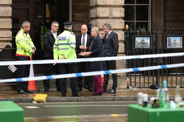 Home Secretary Yvette Cooper speaks to police at the scene