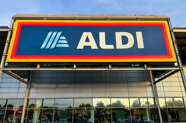  Shoppers enter a branch of the budget supermarket retailer Aldi