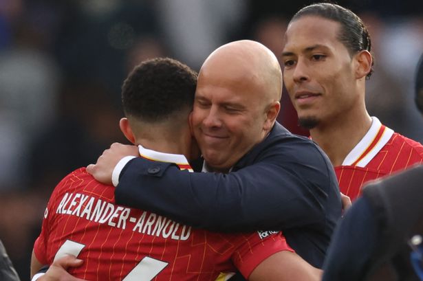 TOPSHOT - Liverpool's Dutch manager Arne Slot embraces goal-scorer Liverpool's English defender #66 Trent Alexander-Arnold on the pitch after the English Premier League football match between Leicester City and Liverpool at King Power Stadium in Leicester, central England on April 20, 2025. Leicester were relegated from the Premier League after a 1-0 defeat to Liverpool. (Photo by Darren Staples / AFP) / RESTRICTED TO EDITORIAL USE. No use with unauthorized audio, video, data, fixture lists, club/league logos or 'live' services. Online in-match use limited to 120 images. An additional 40 images may be used in extra time. No video emulation. Social media in-match use limited to 120 images. An additional 40 images may be used in extra time. No use in betting publications, games or single club/league/player publications. /  (Photo by DARREN STAPLES/AFP via Getty Images)      