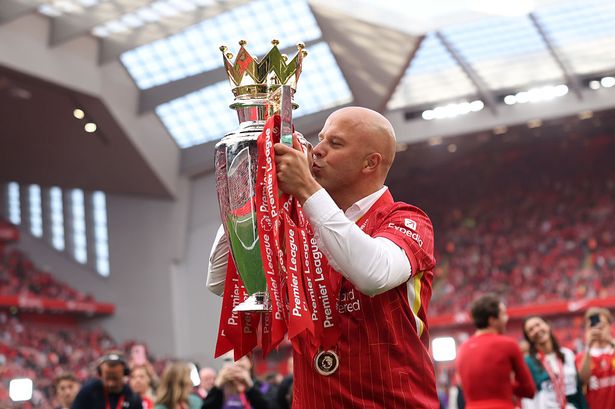 LIVERPOOL, ENGLAND - MAY 25: Arne Slot, Manager of Liverpool,  kisses the Premier League trophy, as Liverpool are crowned the Champions of the Premier League for the 2024/25 Season, following the Premier League match between Liverpool FC and Crystal Palace FC at Anfield on May 25, 2025 in Liverpool, England. (Photo by Carl Recine/Getty Images)