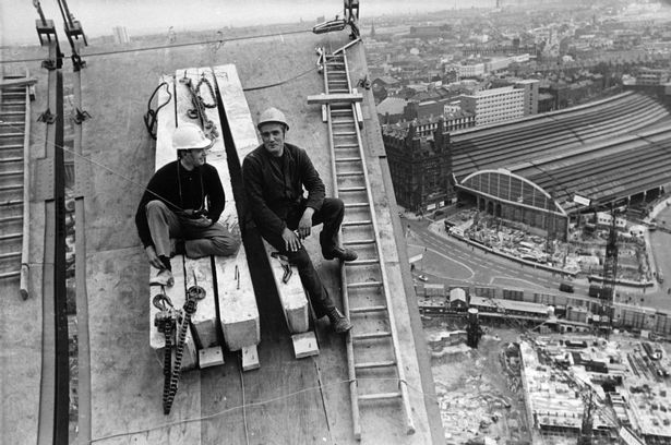 Construction of St Johns Beacon and Precinct. Pictured relaxing on one of the shutters for the revolving restaurant on the Beacon above St Johns Precinct, Liverpool, are Mr David Jones (left) site engineer, and Mr Jean Brunetot, who is in charge of construction of the shuttering. July 1967