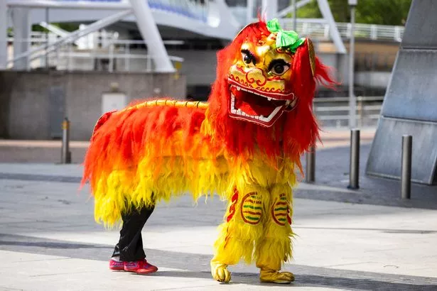 A dragon dancer at the UK Chinese Dragon Boat Race in Salford Quays
