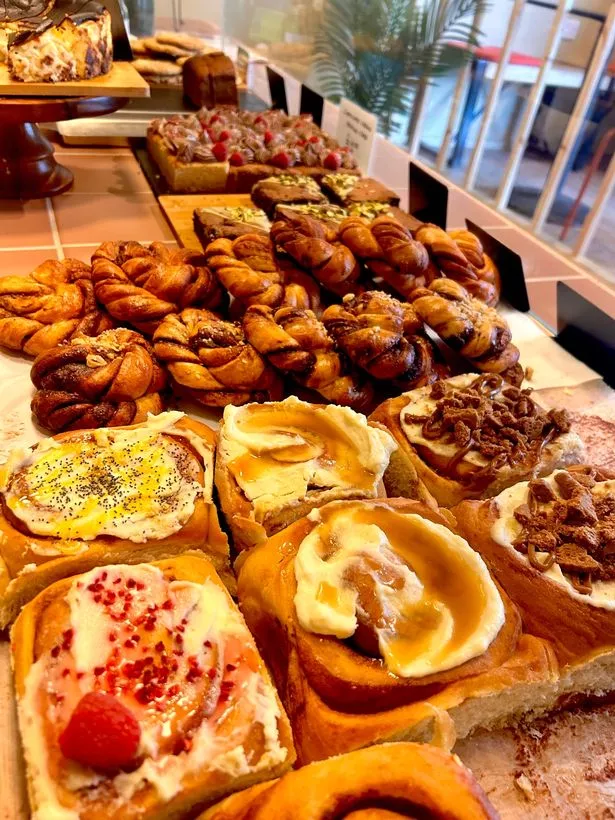 The counter is stocked full of sweet treats including cinnamon buns, babka and brownies 